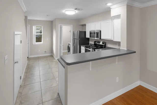 a kitchen with stainless steel appliances a sink stove and refrigerator