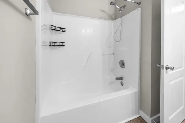 a bathroom with a bathtub and a shower