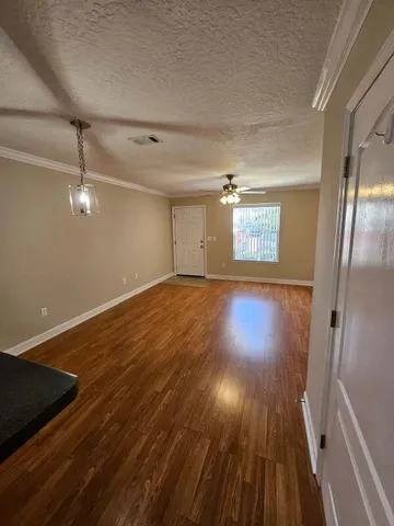 a view of a room with wooden floor