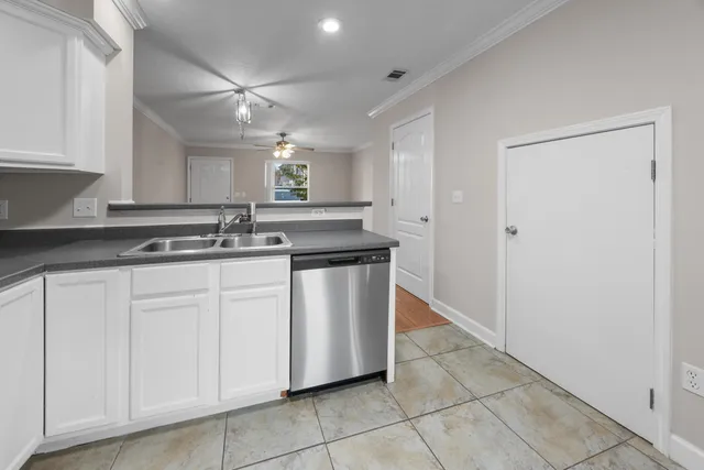 a kitchen with stainless steel appliances granite countertop a sink and a stove