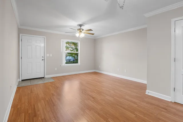 wooden floor in an empty room with a window