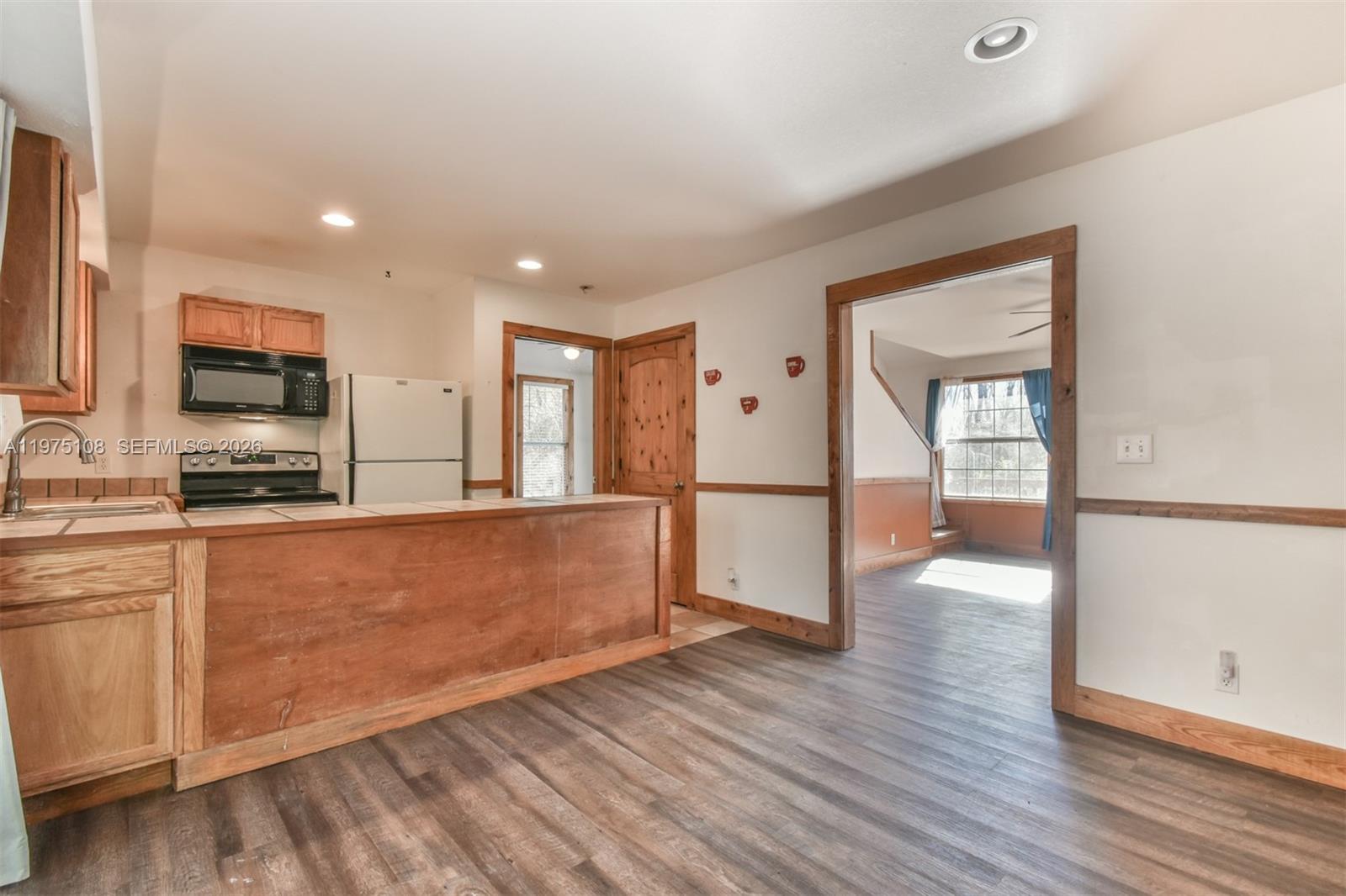 1216 Bugscuffle Road Hiawassee, GA 30546 - Photo 12 of 30 a large kitchen with wooden floor and a appliances