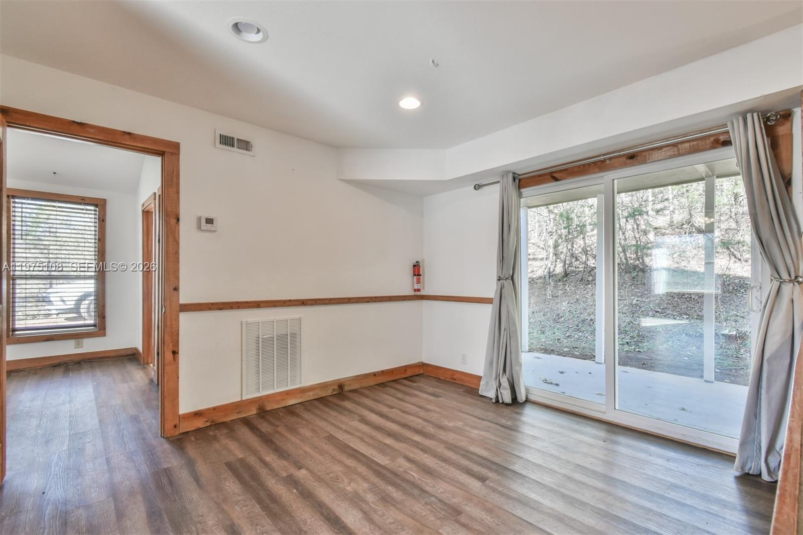 1216 Bugscuffle Road Hiawassee, GA 30546 - Photo 18 of 30 wooden floor in an empty room with a window