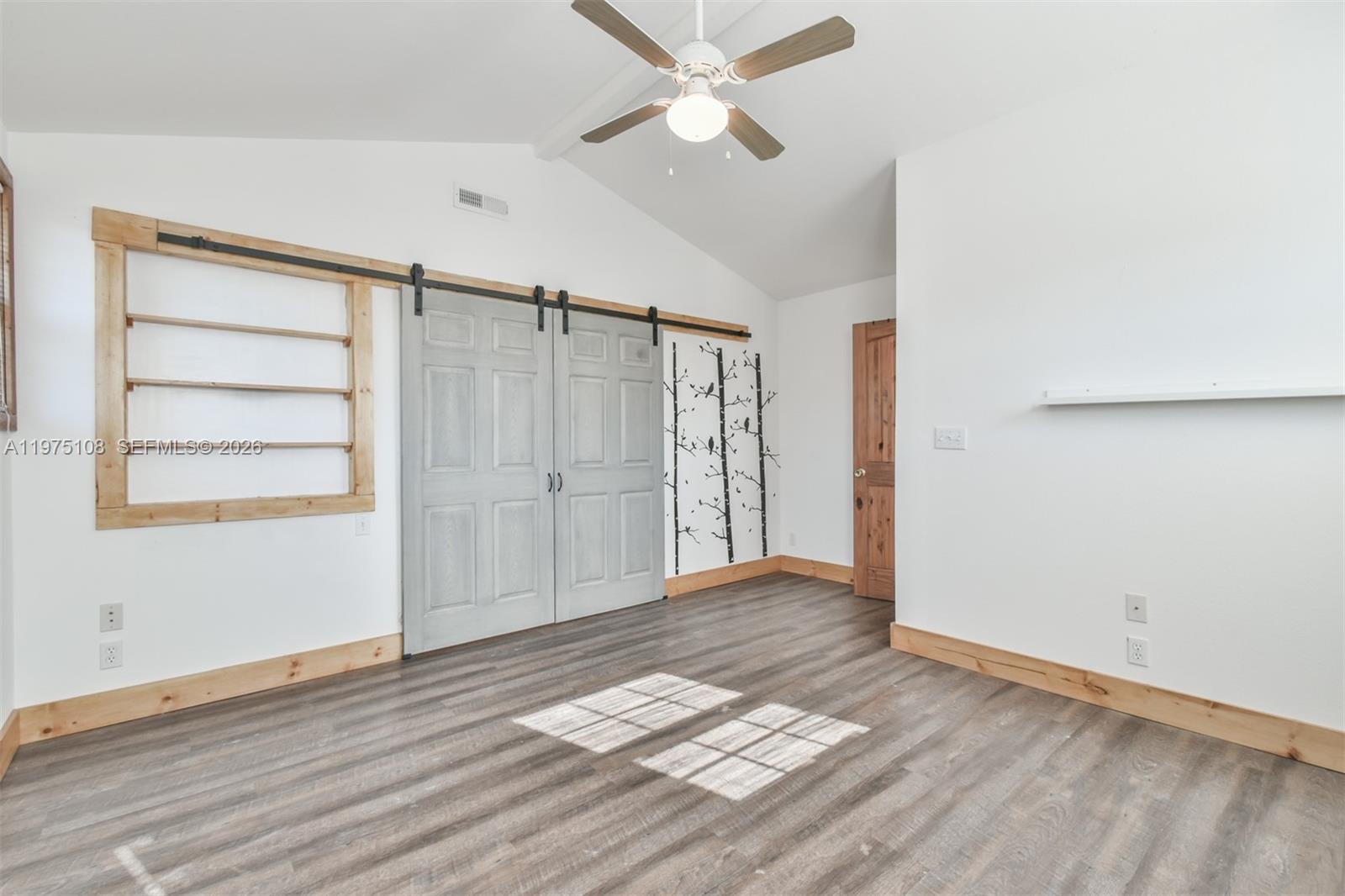 1216 Bugscuffle Road Hiawassee, GA 30546 - Photo 23 of 30 a view of empty room with wooden floor and fan