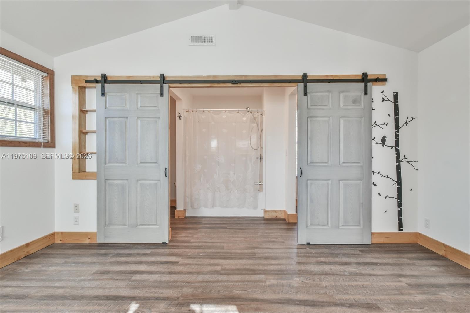 1216 Bugscuffle Road Hiawassee, GA 30546 - Photo 24 of 30 an empty room with wooden floor and windows