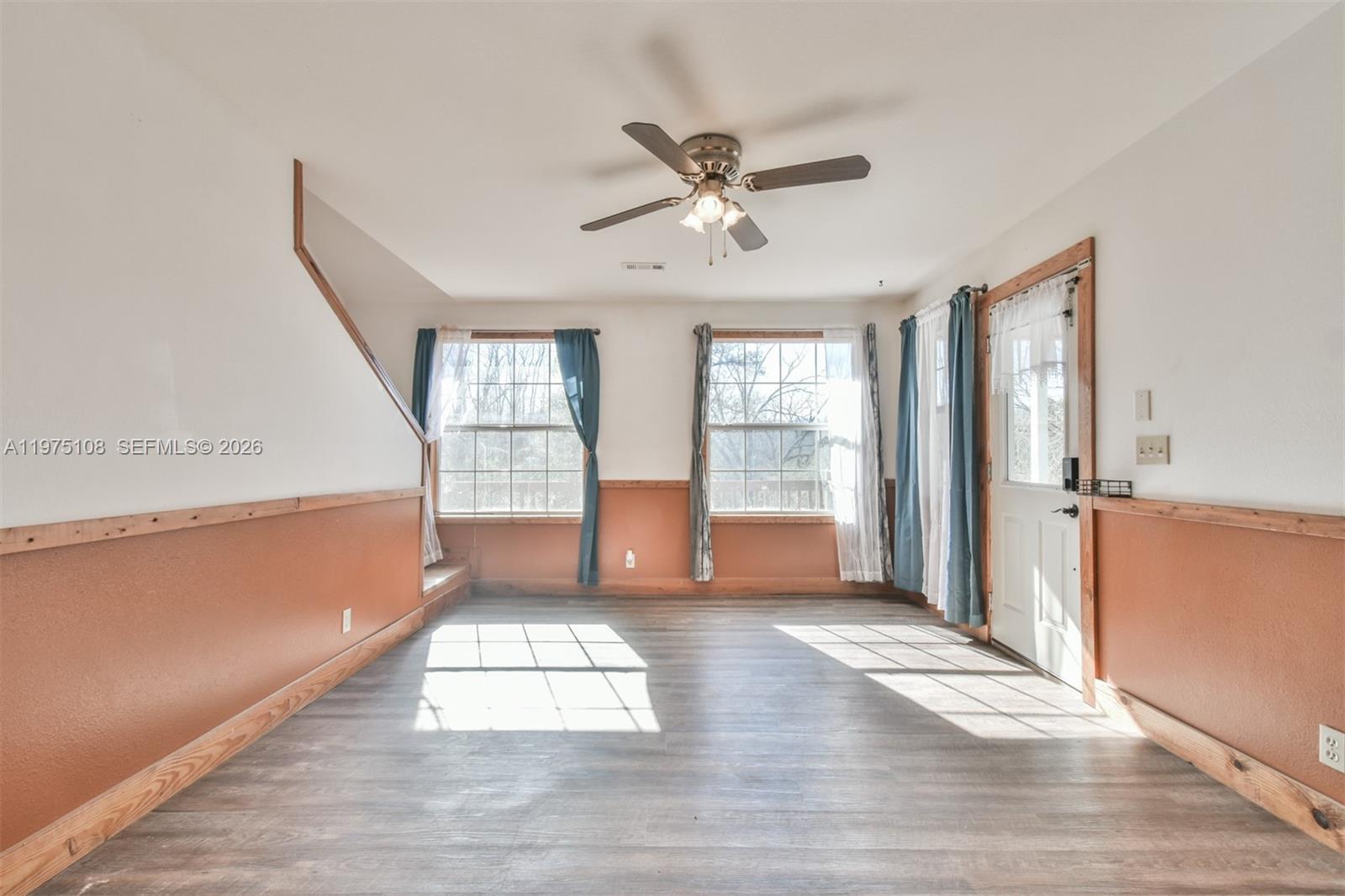 1216 Bugscuffle Road Hiawassee, GA 30546 - Photo 8 of 30 a view of empty room with wooden floor and fan