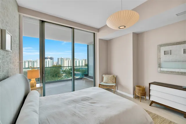 a bedroom with a bed and a lamp next to a window