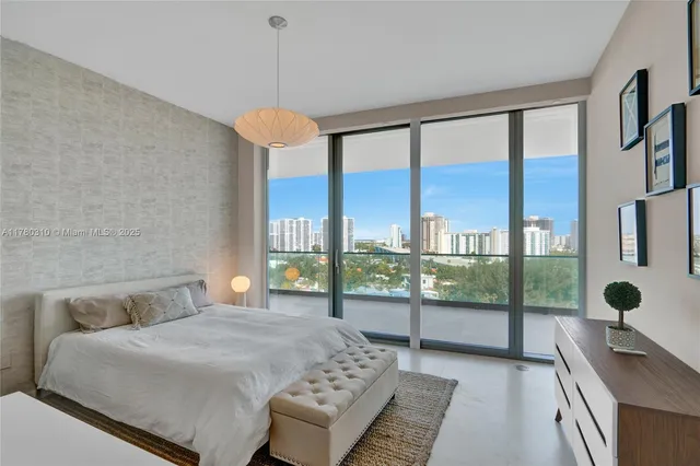 a bedroom with a large bed and a large window