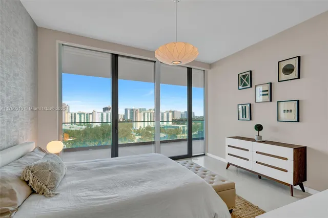 a bedroom with a bed and a large window