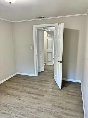 a view of an empty room and wooden floor
