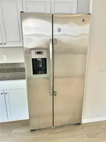 a kitchen with a refrigerator and a stove