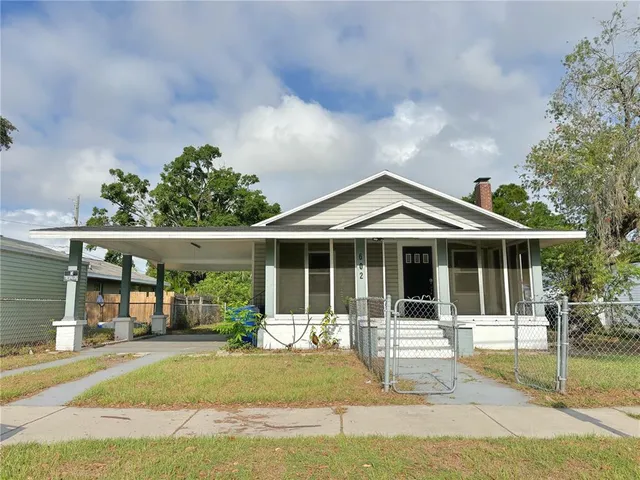a view of a backyard with sitting area