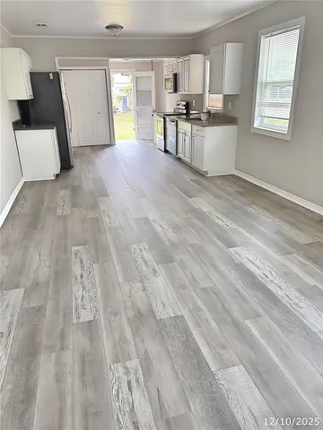 a kitchen with granite countertop a refrigerator and cabinets