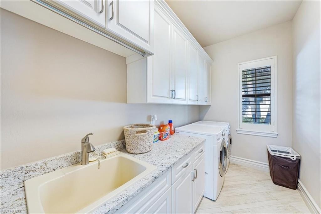 16434 Seneca Way Naples, FL 34110 - Photo 19 of 34 a kitchen with a sink cabinets and window