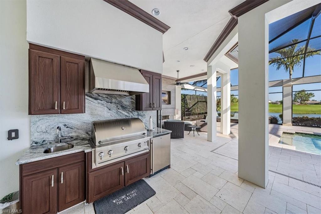 16434 Seneca Way Naples, FL 34110 - Photo 23 of 34 a kitchen with stainless steel appliances granite countertop a stove a sink and a refrigerator
