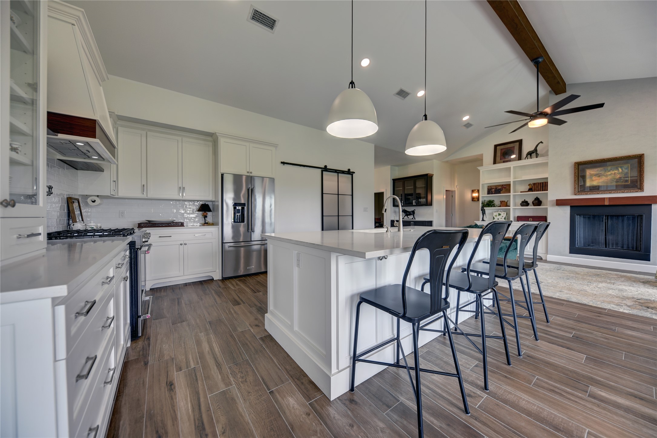 2055 Randle Hill Road Brenham, TX 77833 - Photo 11 of 23 a kitchen with stainless steel appliances kitchen island granite countertop a table chairs microwave and cabinets