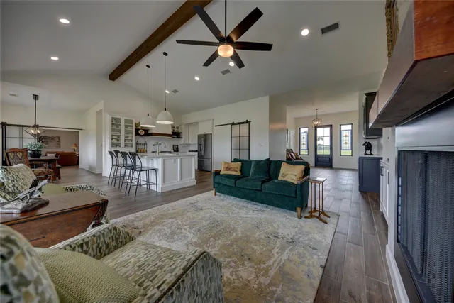 a living room with furniture and a wooden floor