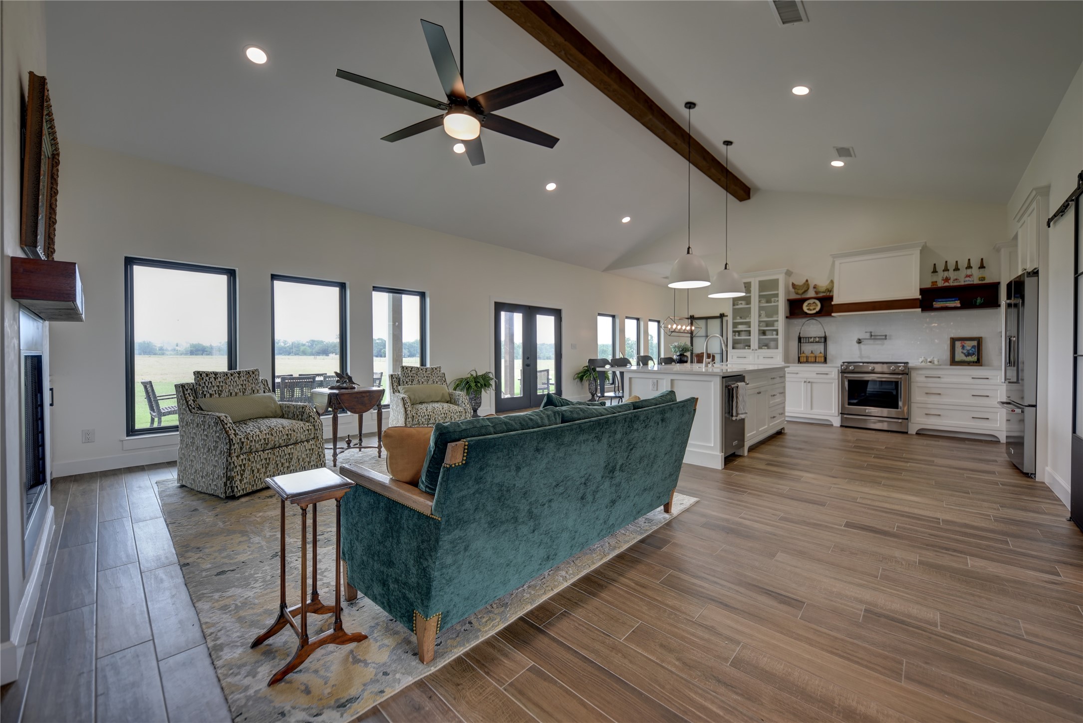 2055 Randle Hill Road Brenham, TX 77833 - Photo 19 of 23 a living room with kitchen island furniture and a flat screen tv
