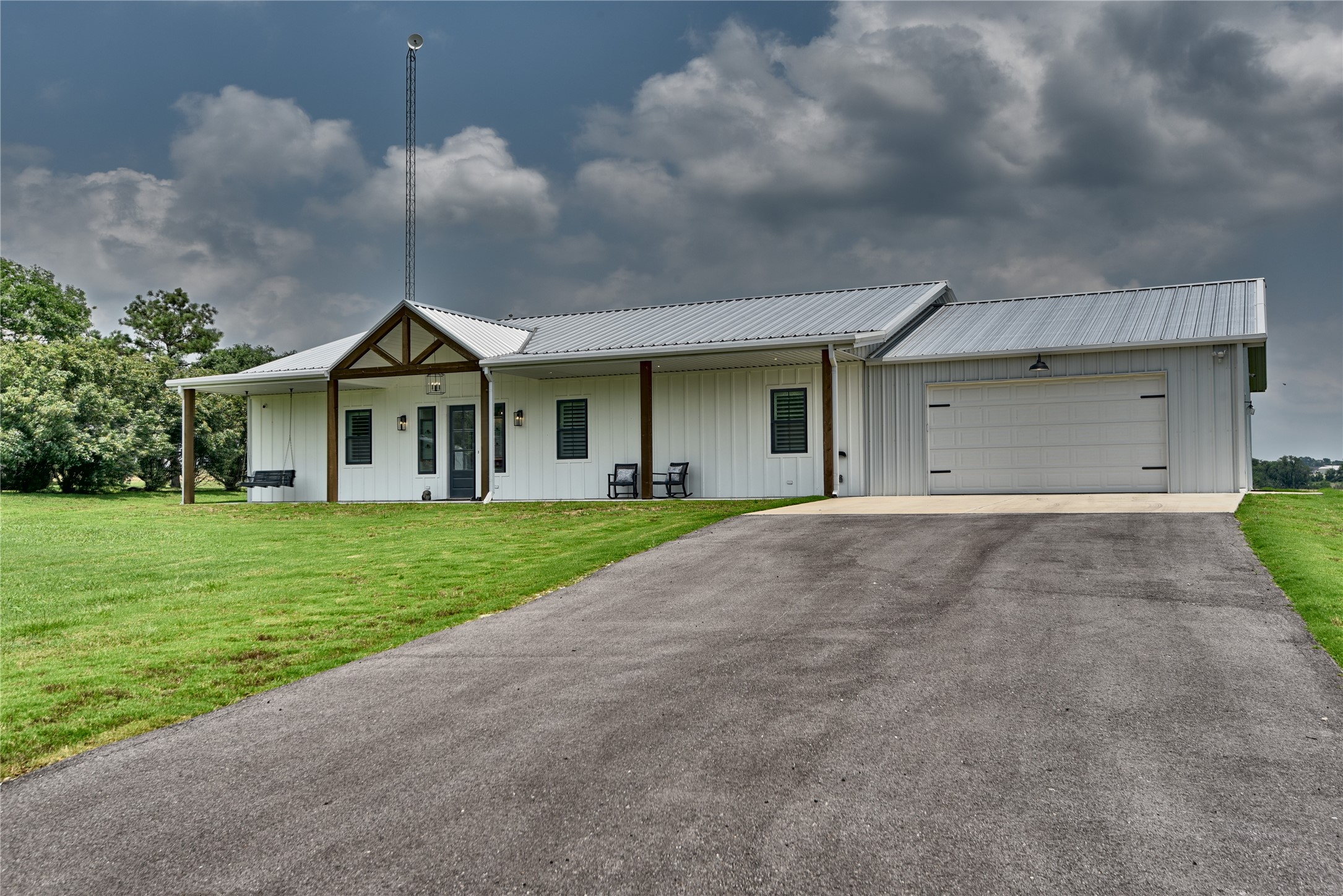 2055 Randle Hill Road Brenham, TX 77833 - Photo 3 of 23 a front view of a house with a yard and garage
