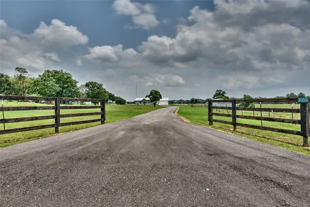 a view of road with grass and a yard