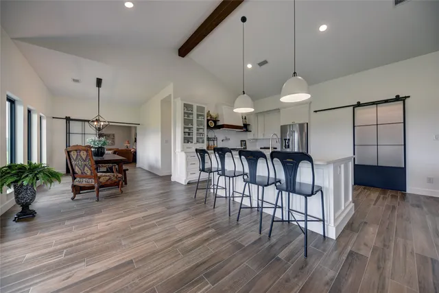 a view of a dining room with furniture and wooden floor