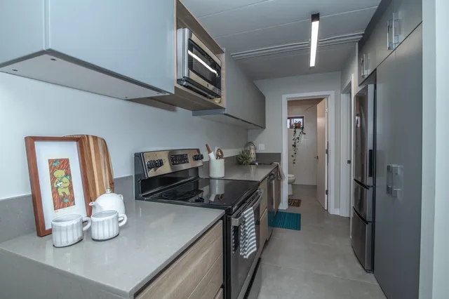 a kitchen with refrigerator and stove