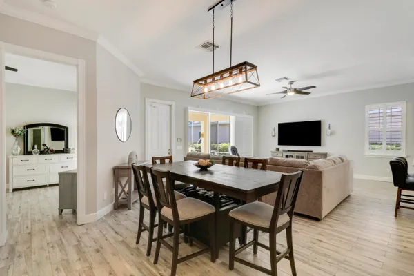 a view of a dining room with furniture window and wooden floor