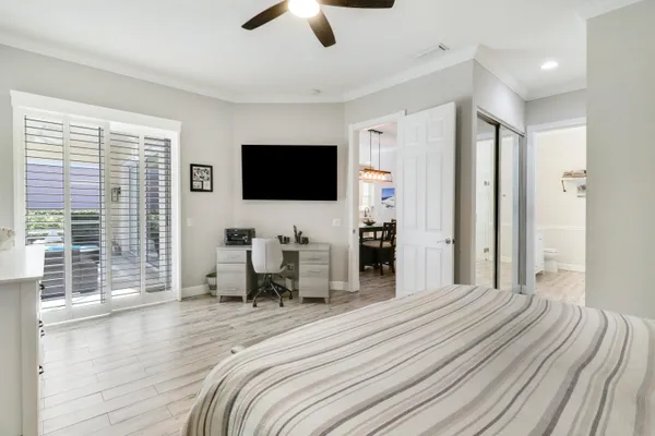 a bedroom with furniture and a flat screen tv