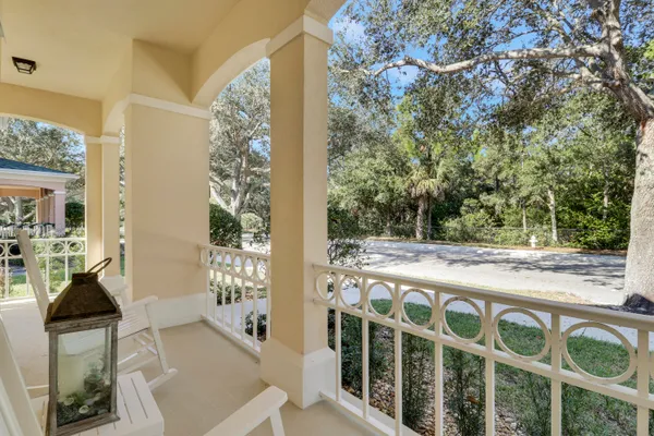 a view of balcony with wooden floor and seating space