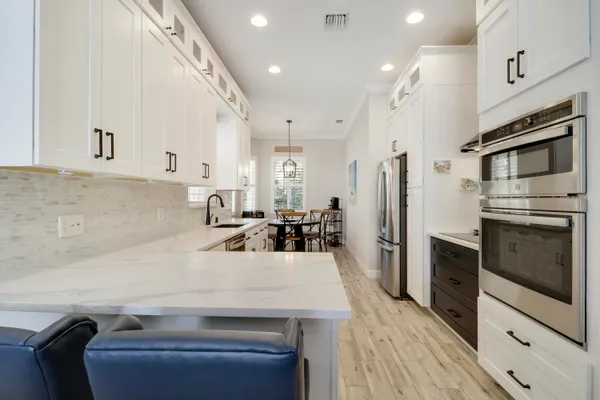 a kitchen with a sink stainless steel appliances and cabinets