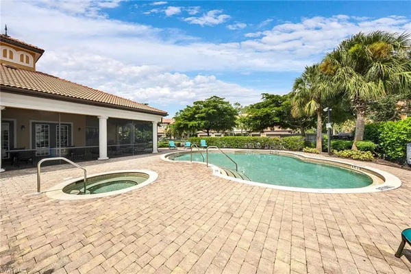 a view of a house with swimming pool and sitting area