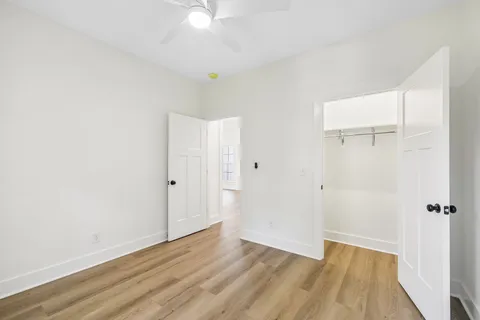 a view of a room with wooden floor