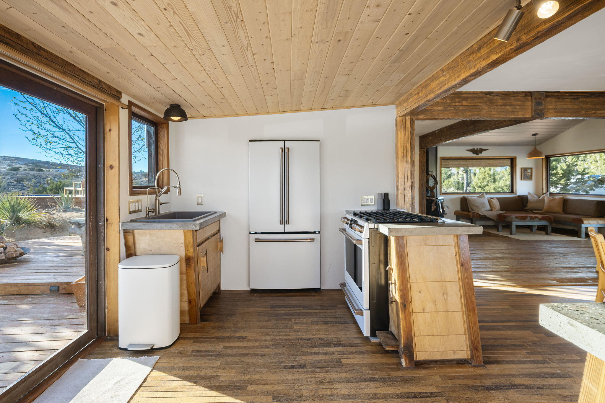 1102 Burlington Road Landers, CA 92285 - Photo 21 of 68 a kitchen with a refrigerator wooden floor and a view of living room