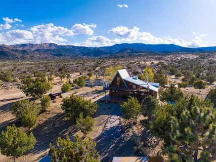 a view of a terrace with a table and chairs under an umbrella