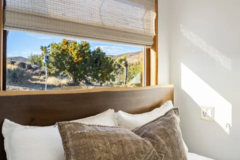 a bedroom with furniture and a window