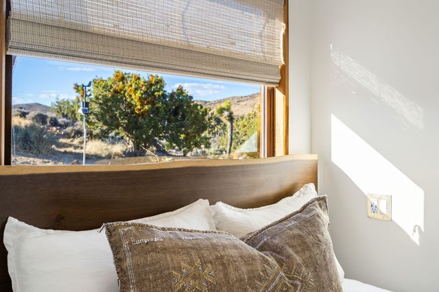 a bedroom with furniture and a window