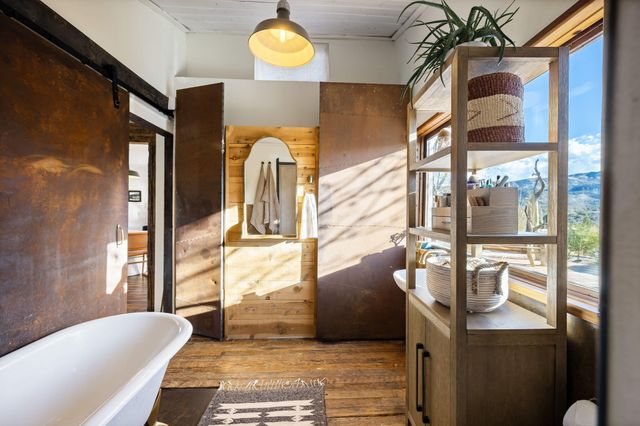 a room with a bed and a dresser