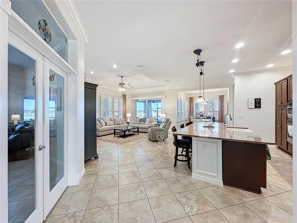 168 Silver Maple Road Groveland, FL 34736 - Photo 13 of 71 a large kitchen with a counter top space a sink a refrigerator and cabinets