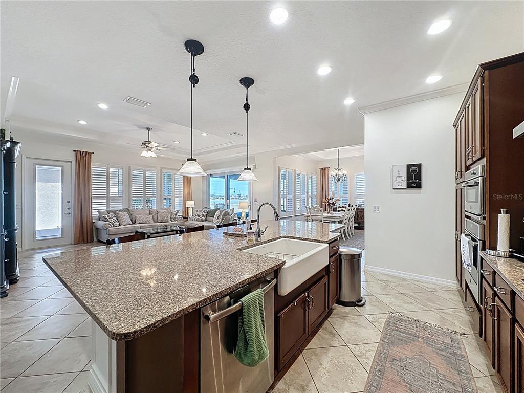 168 Silver Maple Road Groveland, FL 34736 - Photo 15 of 71 a kitchen with stainless steel appliances granite countertop a kitchen island a stove and a sink