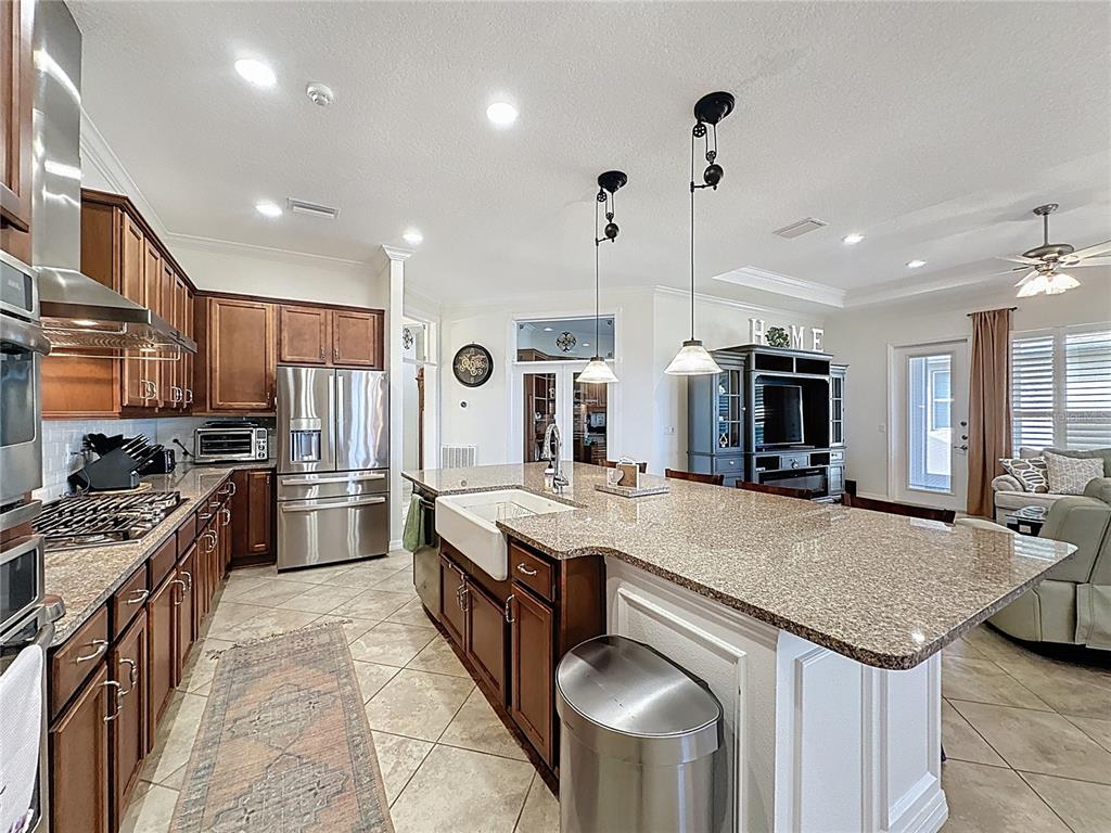 168 Silver Maple Road Groveland, FL 34736 - Photo 16 of 71 a kitchen with stainless steel appliances granite countertop a stove oven and a refrigerator