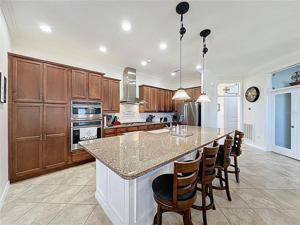 168 Silver Maple Road Groveland, FL 34736 - Photo 17 of 71 a kitchen with a table chairs refrigerator and microwave