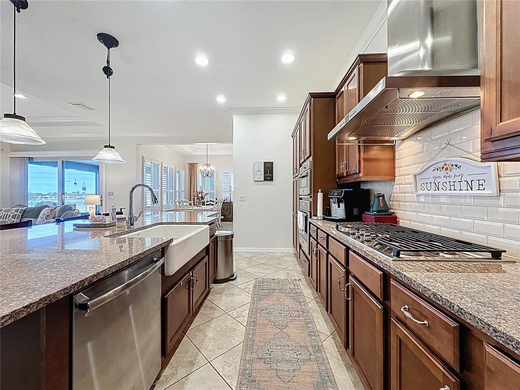 168 Silver Maple Road Groveland, FL 34736 - Photo 19 of 71 a kitchen with stainless steel appliances granite countertop a stove a sink and a refrigerator