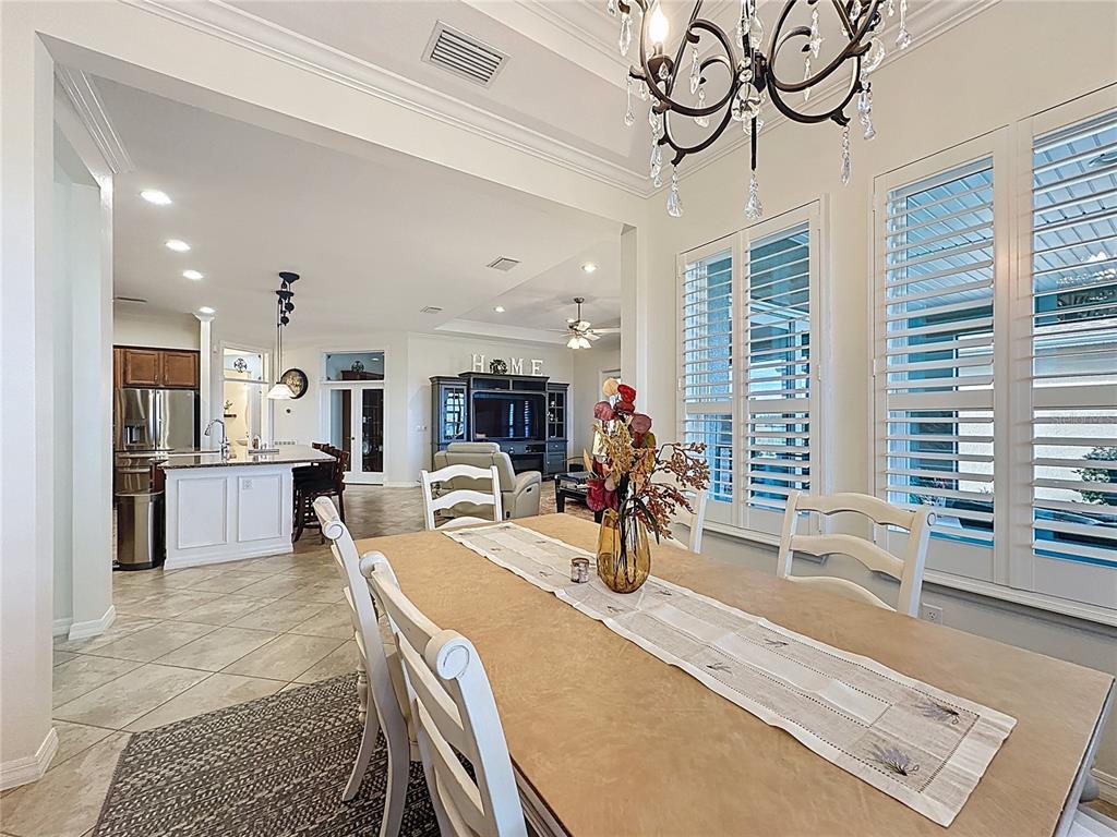 168 Silver Maple Road Groveland, FL 34736 - Photo 22 of 71 a view of a dining room and livingroom with furniture wooden floor a chandelier