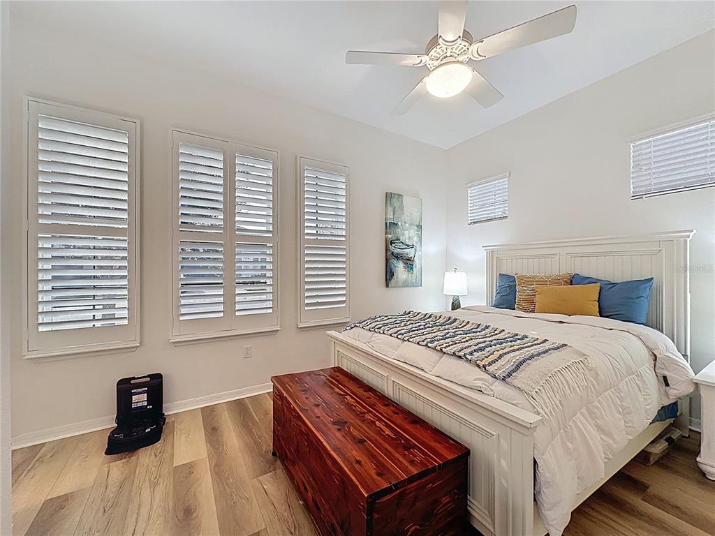 168 Silver Maple Road Groveland, FL 34736 - Photo 24 of 71 a bedroom with a bed and a chandelier