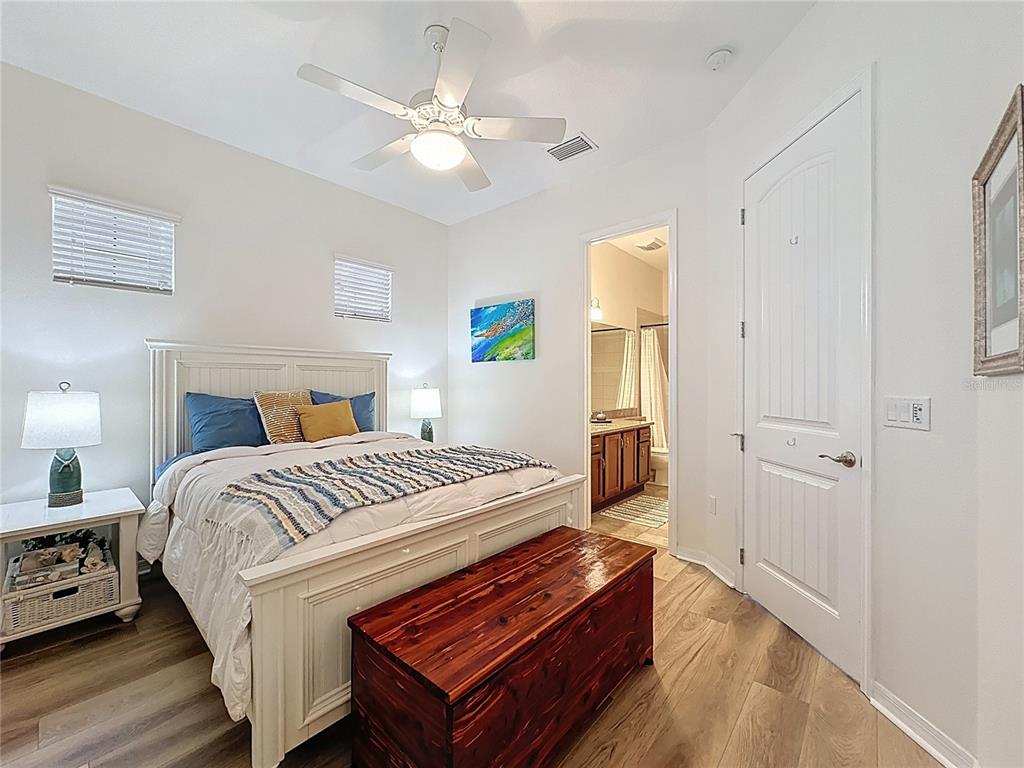 168 Silver Maple Road Groveland, FL 34736 - Photo 25 of 71 a bedroom with a bed and a chandelier