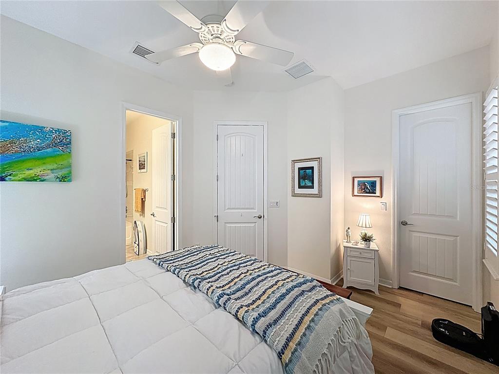 168 Silver Maple Road Groveland, FL 34736 - Photo 26 of 71 a bedroom with a bed and a chandelier