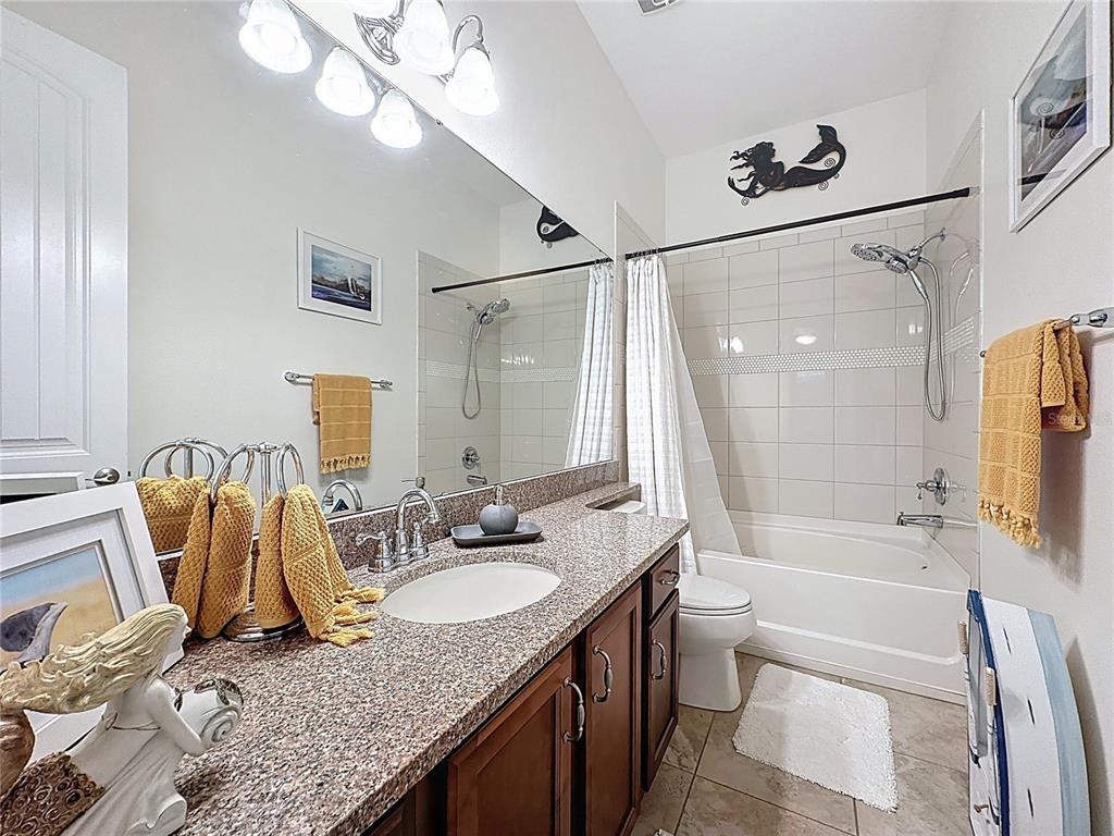 168 Silver Maple Road Groveland, FL 34736 - Photo 28 of 71 a bathroom with a granite countertop sink and a mirror