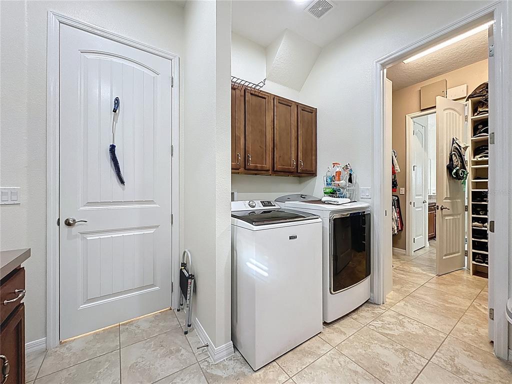 168 Silver Maple Road Groveland, FL 34736 - Photo 30 of 71 a kitchen with granite countertop a refrigerator and a stove top oven