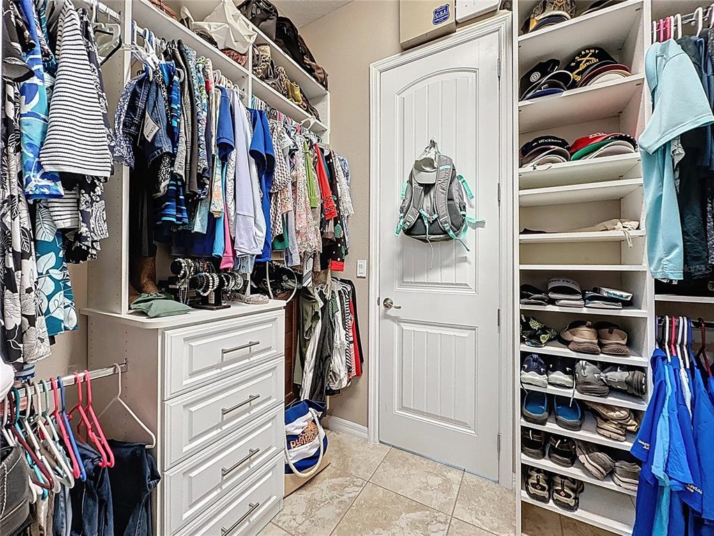 168 Silver Maple Road Groveland, FL 34736 - Photo 32 of 71 a view of walk in closet with clothes and shoes