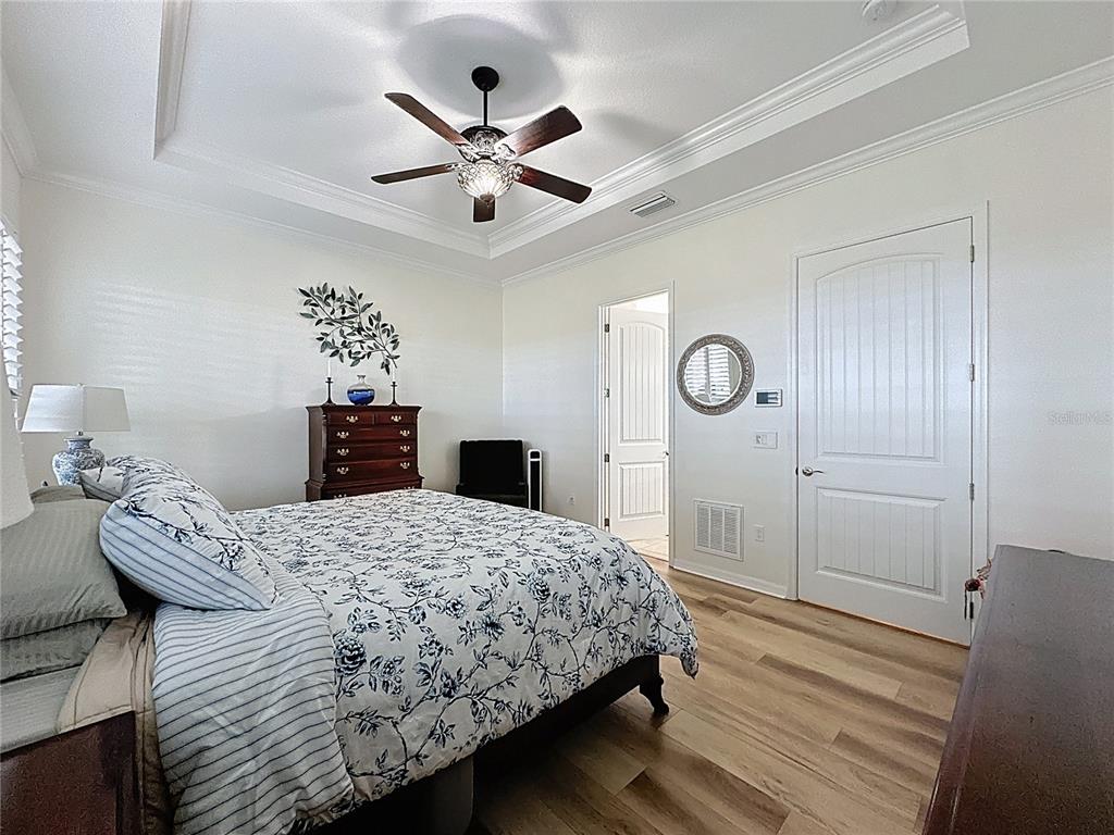 168 Silver Maple Road Groveland, FL 34736 - Photo 35 of 71 a bedroom with a bed and a chandelier